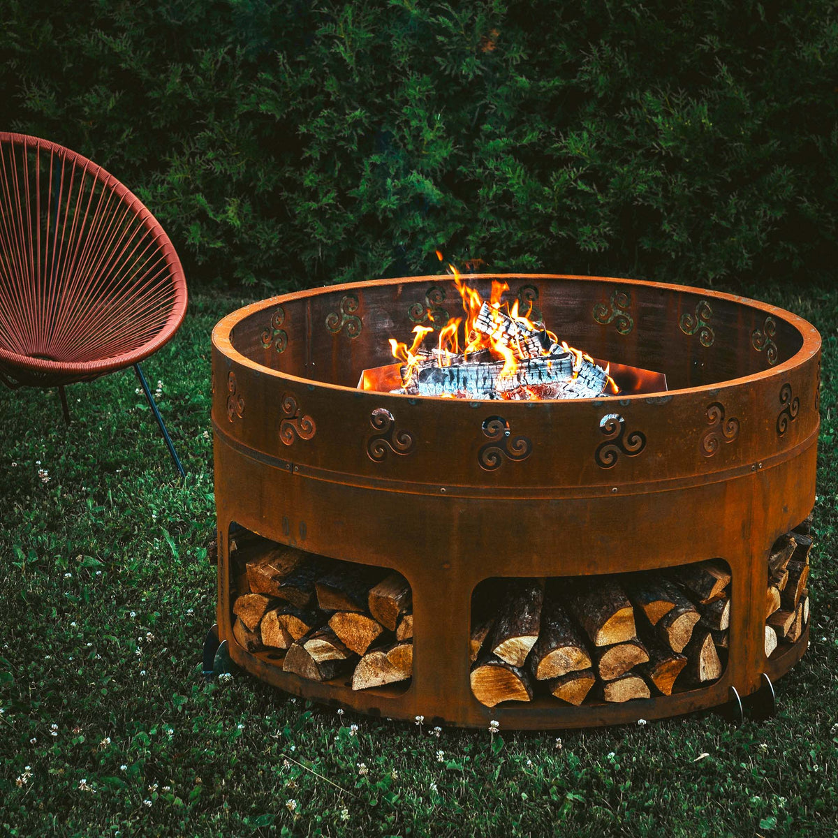 Brasero rond Corten avec rangement à bûches Ø116 cm — Antigo — en situation