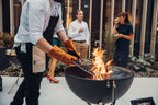 Gril Weber Kettle noir avec flamme orange et grille en métal.