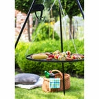 Plateau de gril suspendu noir avec chaînes métalliques et support, conçu pour la cuisson en extérieur