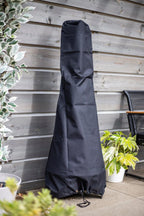 Housse en tissu noir pour un grand gril extérieur.