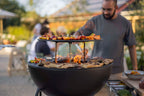 Barbecue au charbon avec plusieurs niveaux et une extérieur noir.