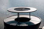 Foyer de feu extérieur circulaire noir et blanc avec design à grille