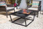 Table de feu en métal noir avec plateau en verre et flammes visibles