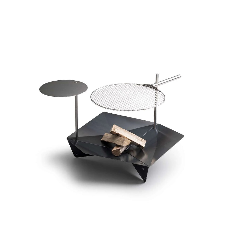 Gril géométrique noir moderne avec surface de cuisson circulaire et table latérale.