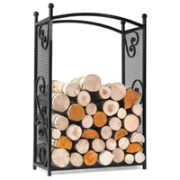 Porte-bûches en fer forgé noir avec décorations en volutes et devant en filet, contenant des bûches empilées soigneusement.