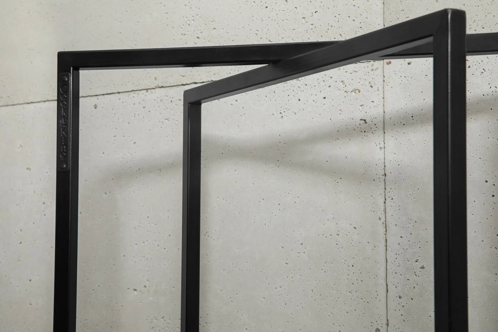 Paroi de douche noire sans cadre avec finition mate et design moderne.