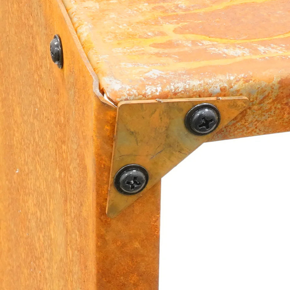 Tabouret en bois avec des équerres métalliques d’angle et une finition usée orange-brun.